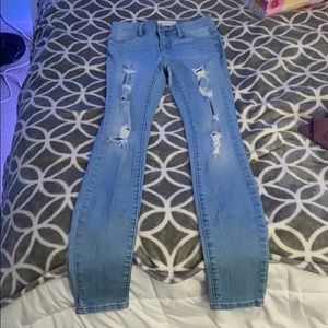 Distressed light blue skinny jeans